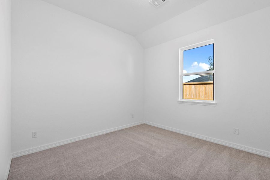 Your secondary bedroom features plush carpet, fresh paint, closet, and a large window that lets in plenty of natural lighting.