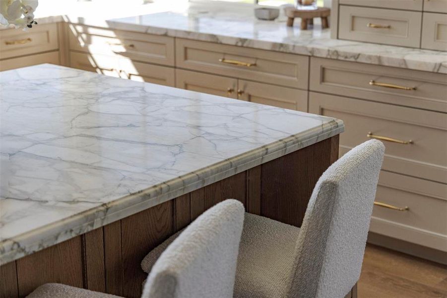 Kitchen featuring light stone countertops and wood finished floors Kitchen featuring light stone countertops and wood finished floors