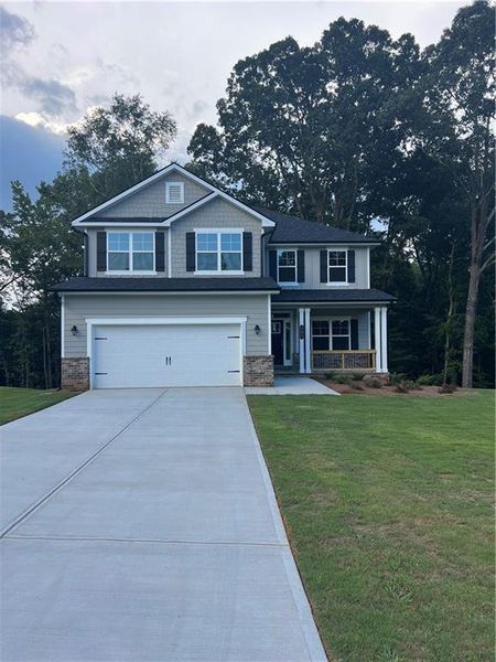 Front exterior of a new home in The Fields of Walnut Creek, Pendergrass, GA, highlighting curb appeal (Image 1). Front exterior of a new home in The Fields of Walnut Creek, Pendergrass, GA, highlighting curb appeal (Image 1).