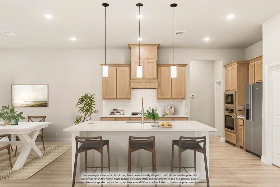 Kitchen with large white island, light wood cabinets, pendant lights, and stainless steel appliances Kitchen with large white island, light wood cabinets, pendant lights, and stainless steel appliances