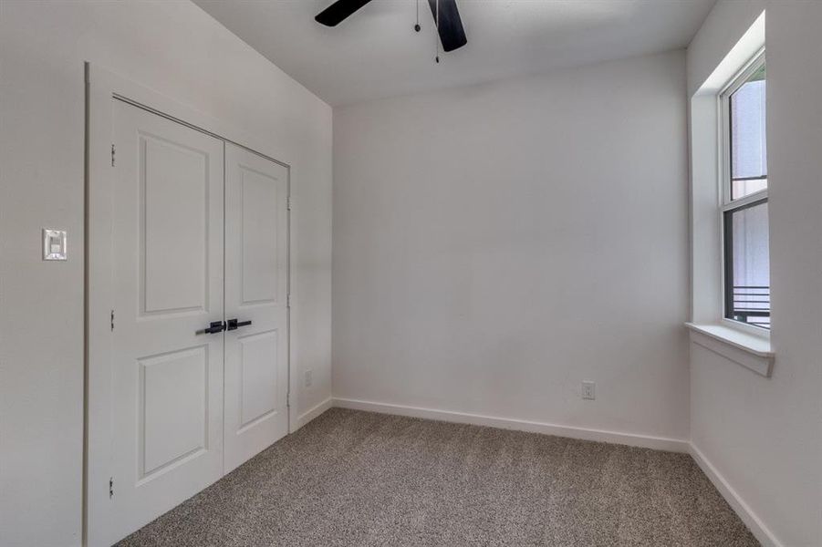 Unfurnished bedroom with carpet floors, a closet, and ceiling fan