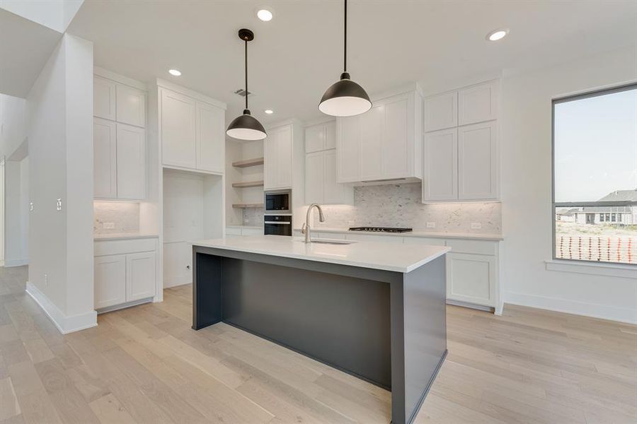 Kitchen with white cabinets, backsplash, open shelves, pendant lighting, and recessed lighting