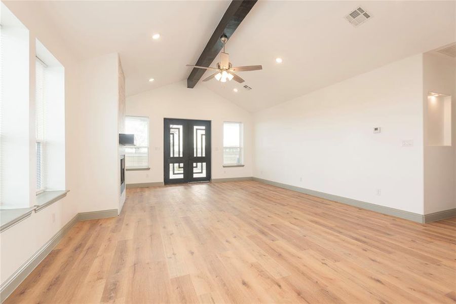 Unfurnished living room with light wood-style flooring, ceiling fan, and recessed lighting