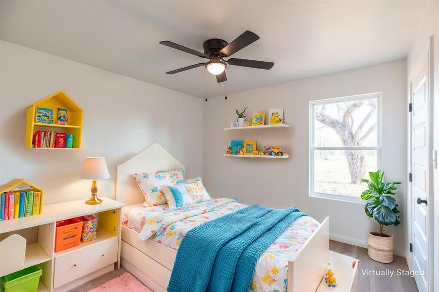 Bedroom featuring ceiling fan and wood finished floors