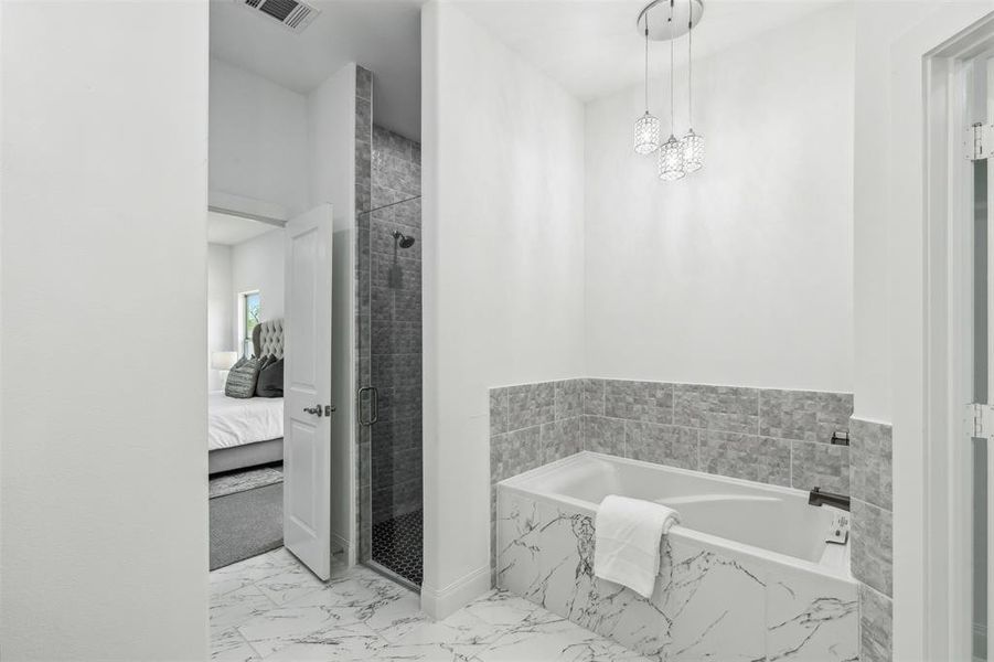 Bathroom with tile patterned flooring and independent shower and bath