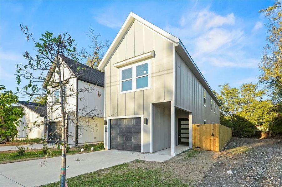 View of front of property featuring board and batten siding, concrete driveway, and a garage View of front of property featuring board and batten siding, concrete driveway, and a garage