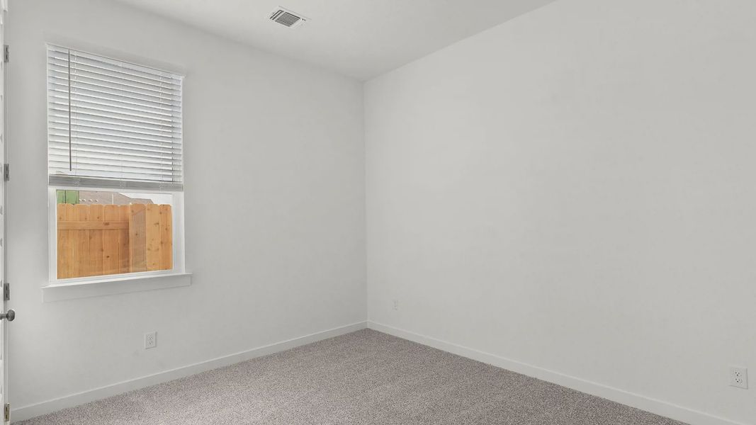 Representative unfurnished interior of a home built from the Lauren by Chesmar Homes in University Heights, Round Rock (Image 16).