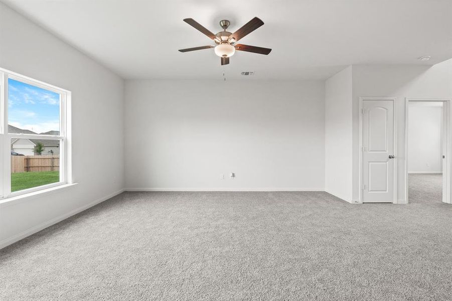 Spare room with carpet and ceiling fan