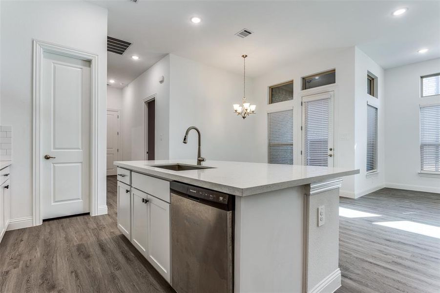 White kitchen, SS appliances high ceilings and canned lighting with gas cook top and vented exhaust