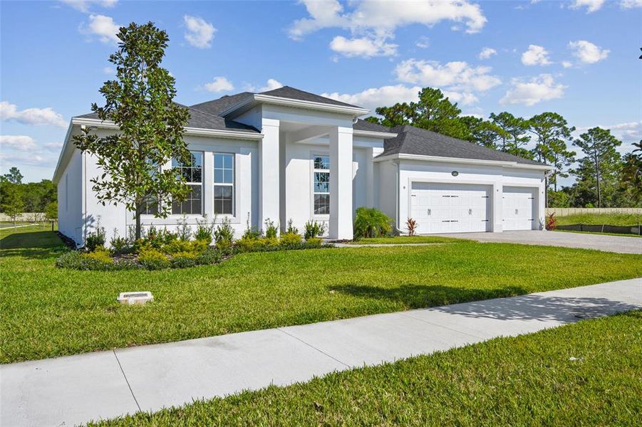 Front exterior of a new home in Hawk's Overlook, Oviedo, FL, highlighting curb appeal (Image 29). Front exterior of a new home in Hawk's Overlook, Oviedo, FL, highlighting curb appeal (Image 29).