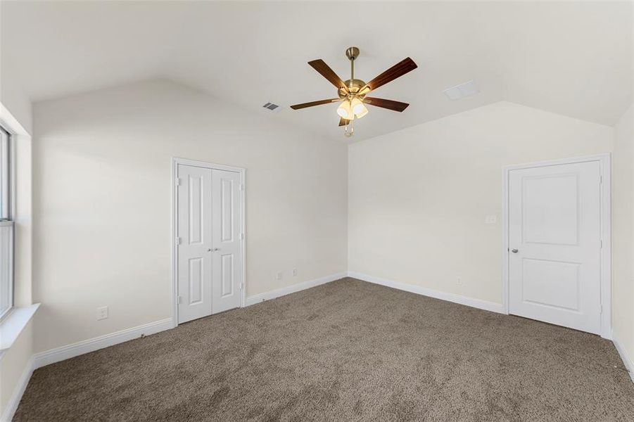 Unfurnished bedroom with carpet flooring, ceiling fan, and a closet