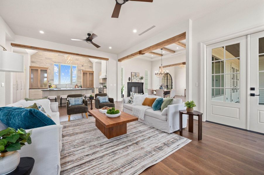 Living room featuring a chandelier, beam ceiling, wood finished floors, recessed lighting, and ceiling fan
