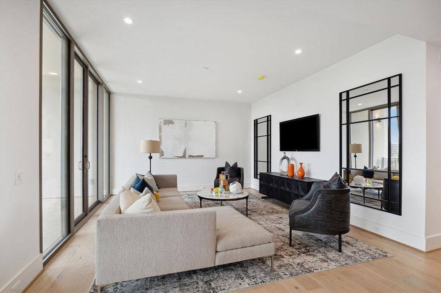 Floor-to-ceiling sliding glass doors in the living room effortlessly blur the line between indoor comfort and outdoor allure.