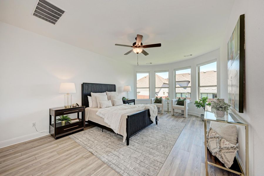 Primary Bedroom with Bay Windows giving views of the Back Yard