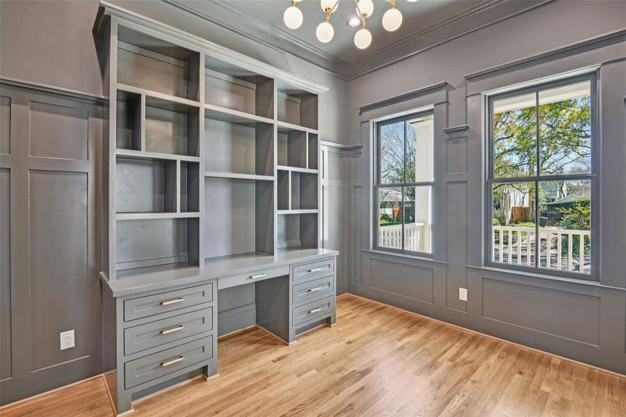 The study features a built in and is painting in a uniform dark gray. The study features a built in and is painting in a uniform dark gray.