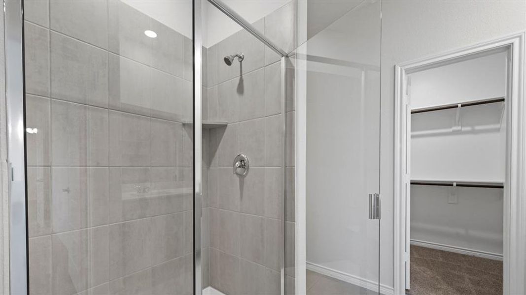 Full bathroom with a spacious closet and a shower stall Full bathroom with a spacious closet and a shower stall