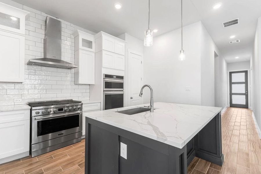 Culinary creations come to life in this kitchen, featuring stainless steel appliances and an oversized island for effortless entertaining. Culinary creations come to life in this kitchen, featuring stainless steel appliances and an oversized island for effortless entertaining.