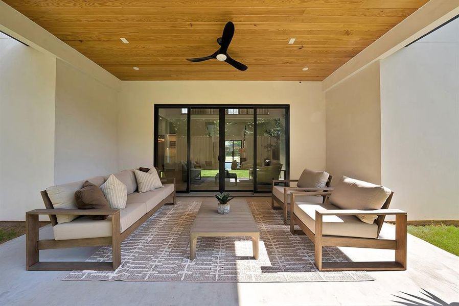 Covered outdoor patio featuring a wood-finish ceiling with recessed lighting and a ceiling fan
