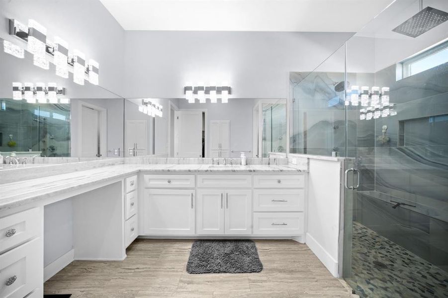 Full bathroom with a shower stall, vanity, and light wood-style flooring