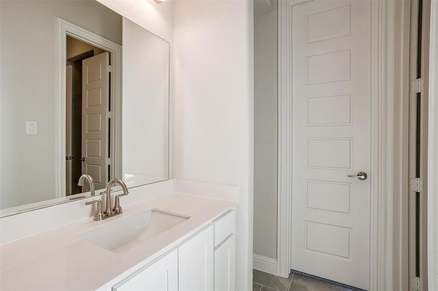 Bathroom with tile patterned flooring and vanity