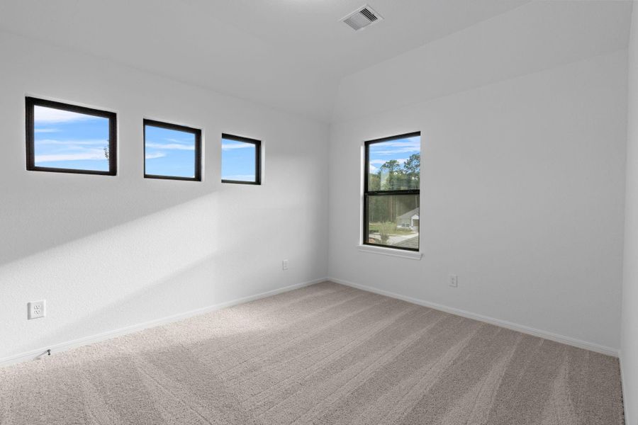 Your secondary bedroom features plush carpet, fresh paint, closet, and a large window that lets in plenty of natural lighting.