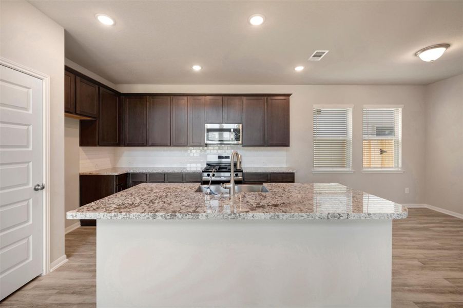 Chef-worthy island kitchen (*Photo not of actual home and used for illustration purposes only.)