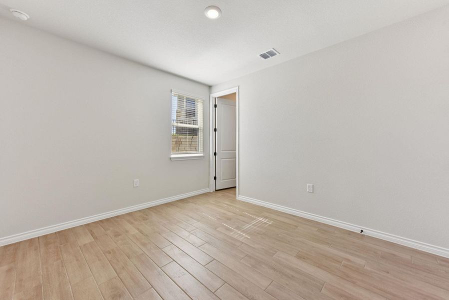 Unfurnished room with light wood-style flooring and recessed lighting