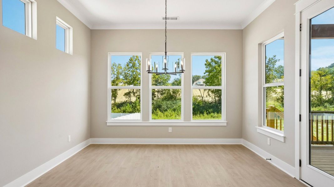 Dining area with hanging light next to backyard door Dining area with hanging light next to backyard door