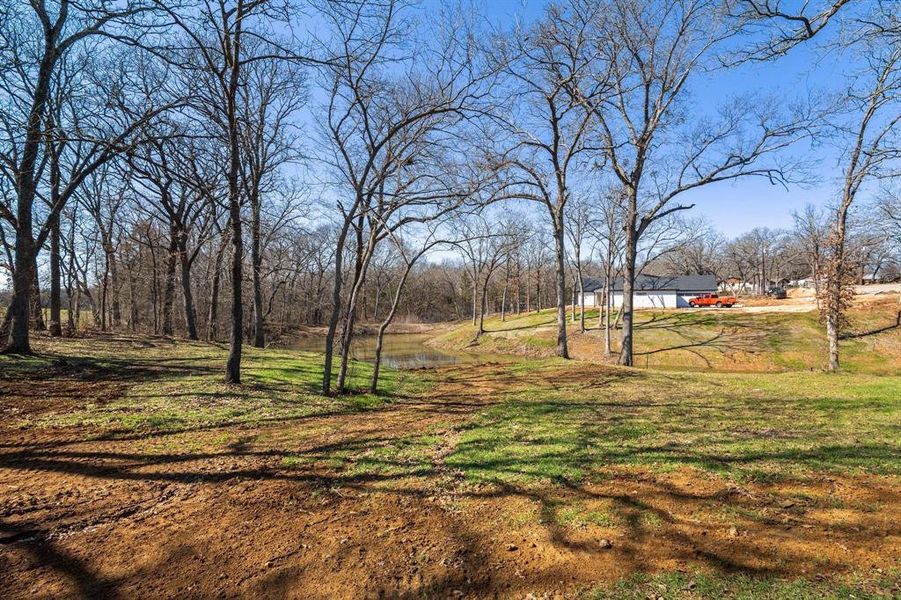 View of green lawn featuring a water view View of green lawn featuring a water view