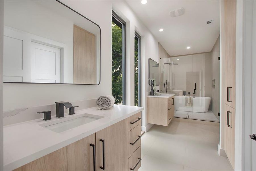 Bathroom featuring vanity and shower with separate bathtub