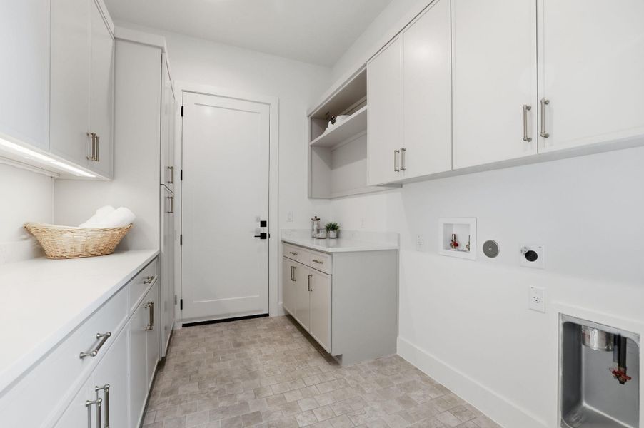 Laundry room featuring cabinet space, hookup for a washing machine, hookup for a gas dryer, and electric dryer hookup