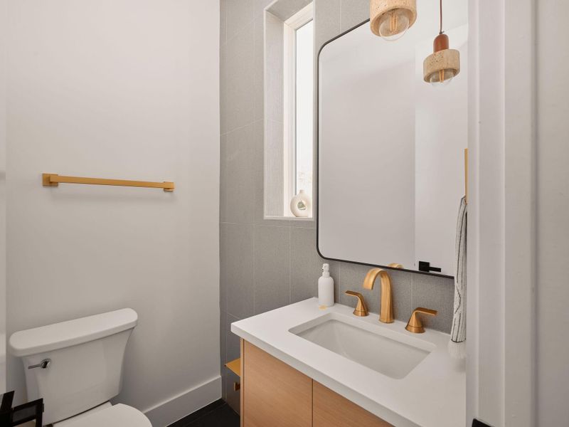 Half bath featuring vanity and toilet