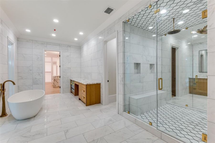 Bathroom with crown molding, tile walls, and shower with separate bathtub