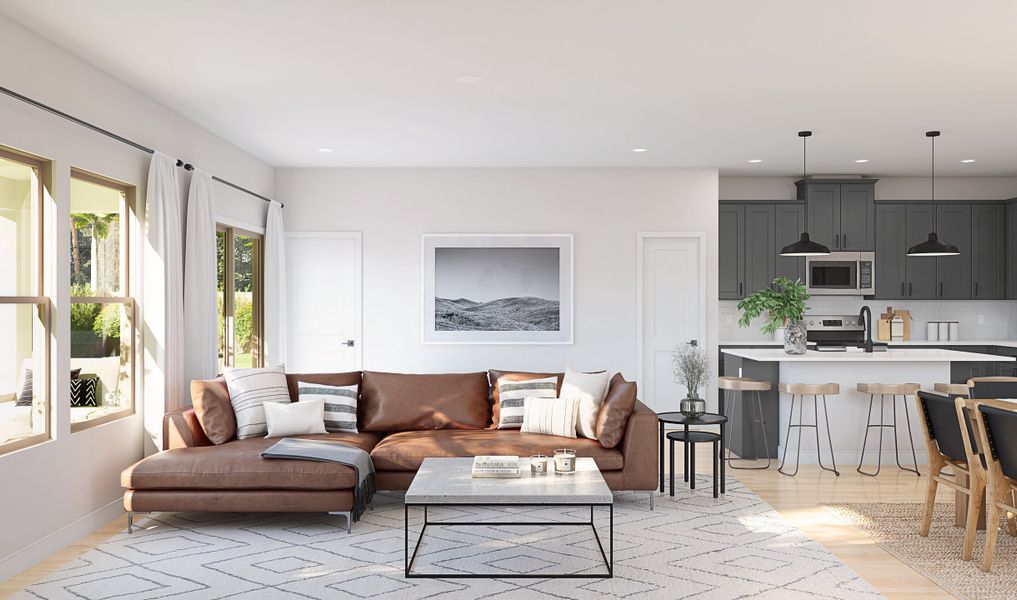 Great room w/ natural light adjacent to the kitchen ideal for entertaining