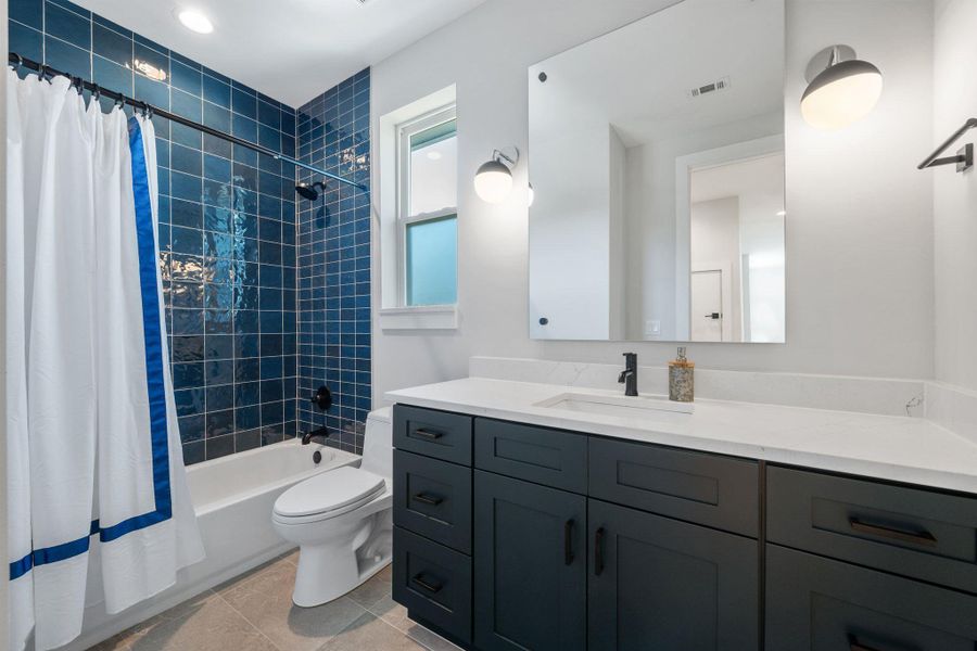 Full bathroom with shower / bathtub combination with curtain, vanity, light tile patterned flooring, and recessed lighting