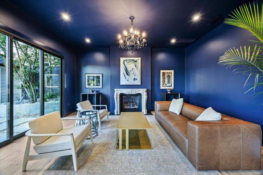 Living area featuring a chandelier, ntique marble fireplace Living area featuring a chandelier, ntique marble fireplace