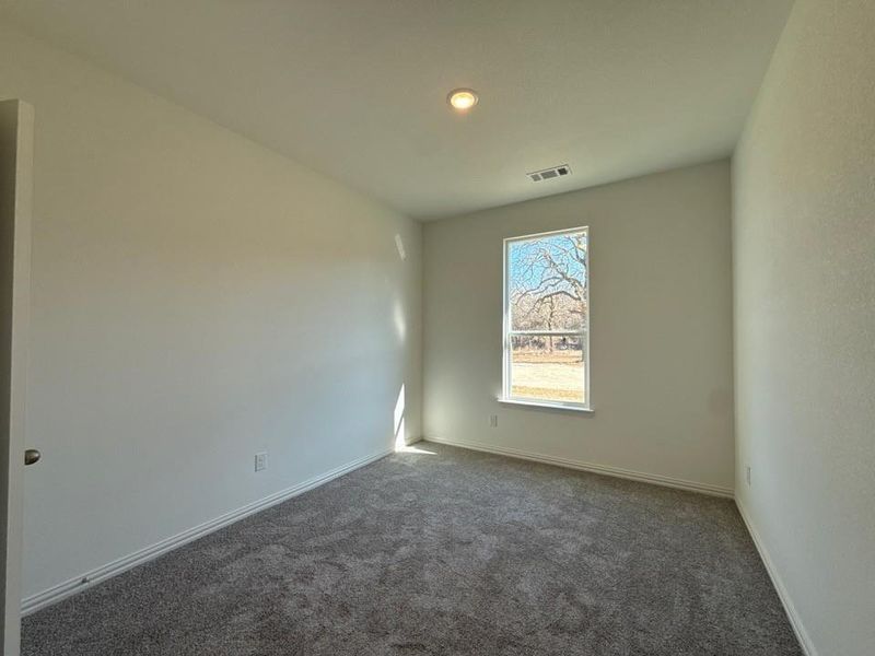 Spare room with dark colored carpet and recessed lighting
