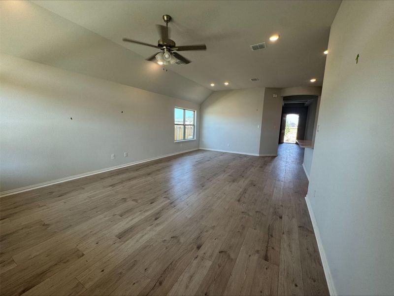 Spare room featuring vaulted ceiling, a ceiling fan, recessed lighting, and wood finished floors Spare room featuring vaulted ceiling, a ceiling fan, recessed lighting, and wood finished floors
