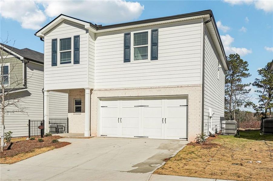 Front exterior of a new home in Hawthorne Station, College Park, GA, highlighting curb appeal (Image 30). Front exterior of a new home in Hawthorne Station, College Park, GA, highlighting curb appeal (Image 30).