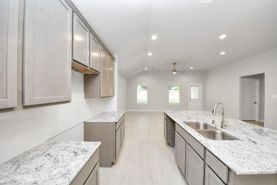 All of this overlooks your expansive family room, creating a perfect space for culinary delights and family gatherings. Sample photo of completed home with similar floor plan. Actual colors and selections may vary.