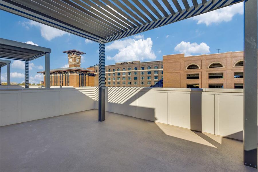 View of rooftop patio featuring a pergola and a great view!