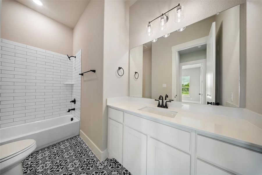 Bathroom featuring vanity, tile patterned floors, and shower / tub combination Bathroom featuring vanity, tile patterned floors, and shower / tub combination