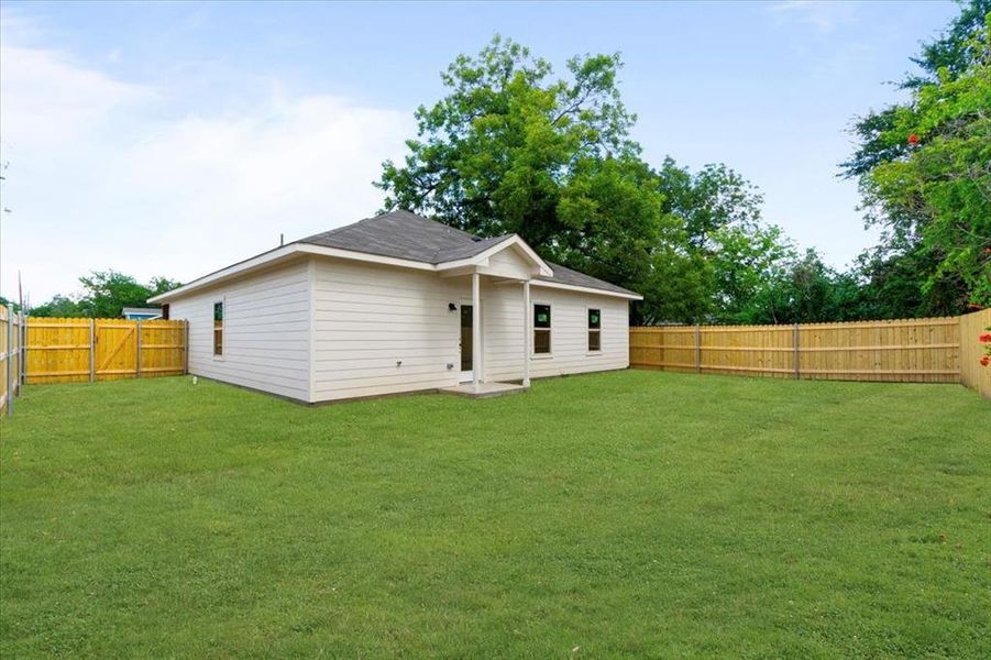 Back of house featuring a lawn