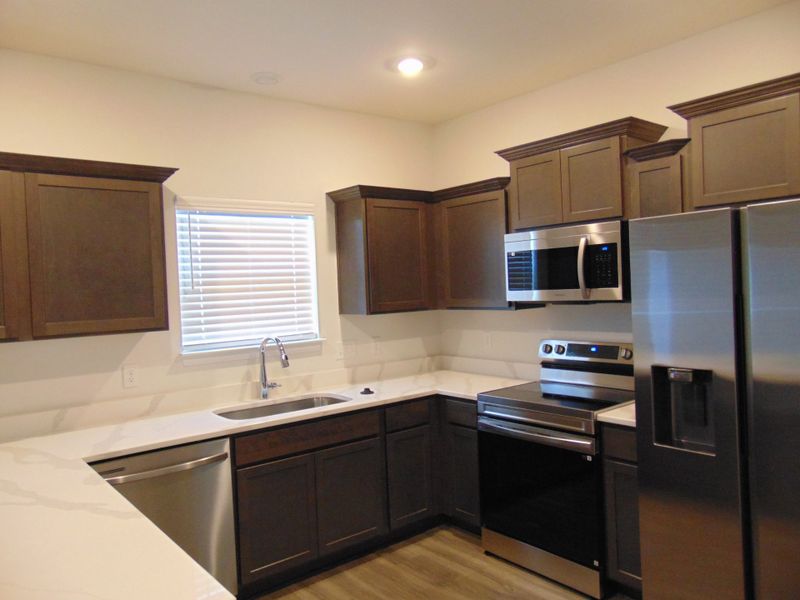 This is a sleek and modern kitchen to cook your family meals has stainless steel appliances and staggered cabinetry, as well as dreamy crowns This is a sleek and modern kitchen to cook your family meals has stainless steel appliances and staggered cabinetry, as well as dreamy crowns