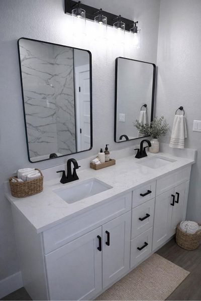 Bathroom with double vanity, a textured wall, and dark wood-style floors