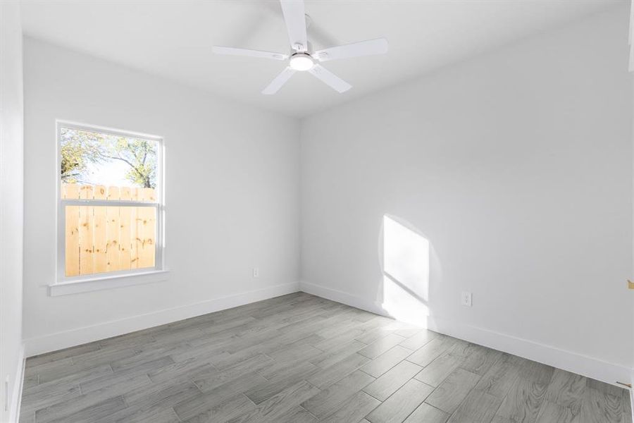 Empty room featuring ceiling fan and light wood-type flooring