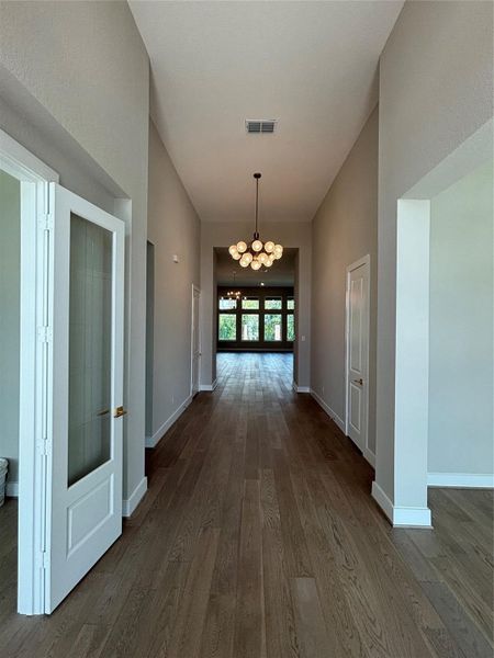Gorgeous entryway with view of the spacious family room beyond (ACTUAL HOME)