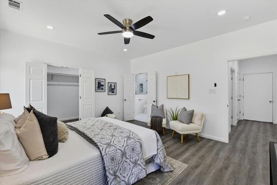 Primary Bedroom featuring a spacious walk-in closet, LVP flooring, recessed lighting, and a ceiling fan