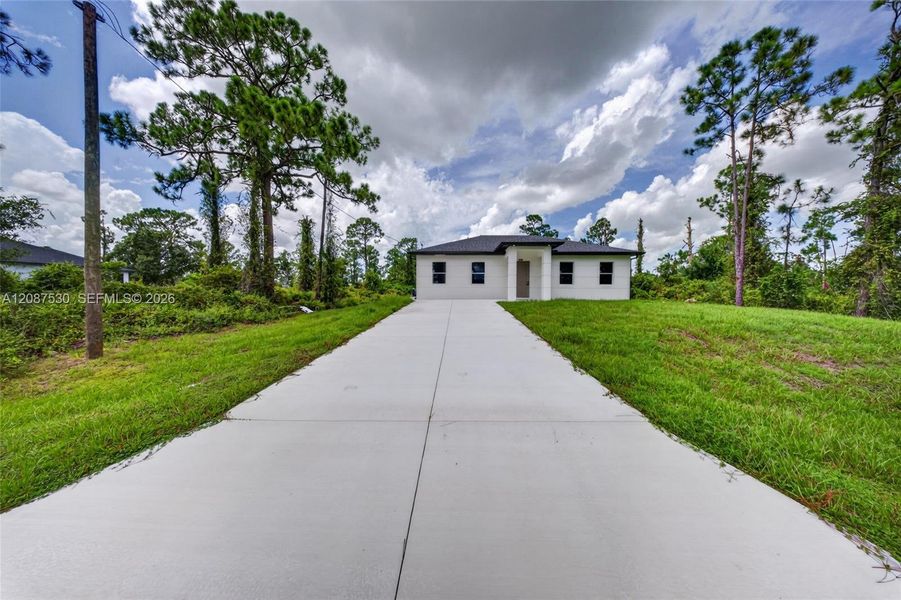 Front exterior of a new home in , Lehigh Acres, FL, highlighting curb appeal (Image 23).