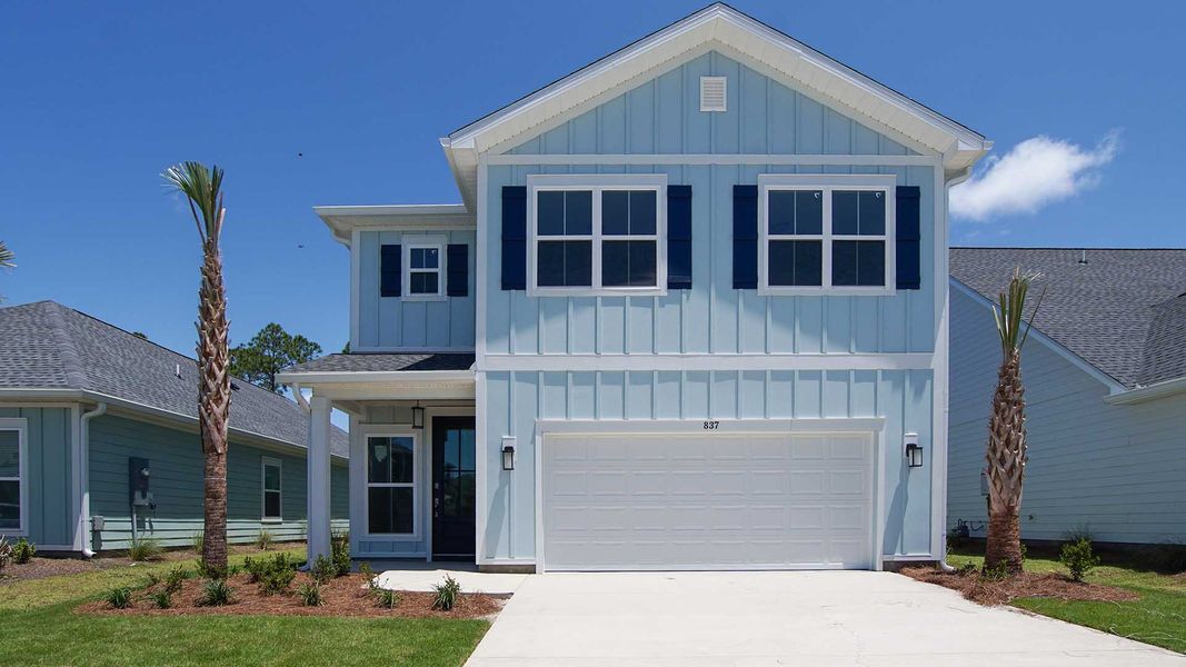 Front exterior of a new home in Breakfast Point East Phase I, Panama City Beach, FL, highlighting curb appeal (Image 1).